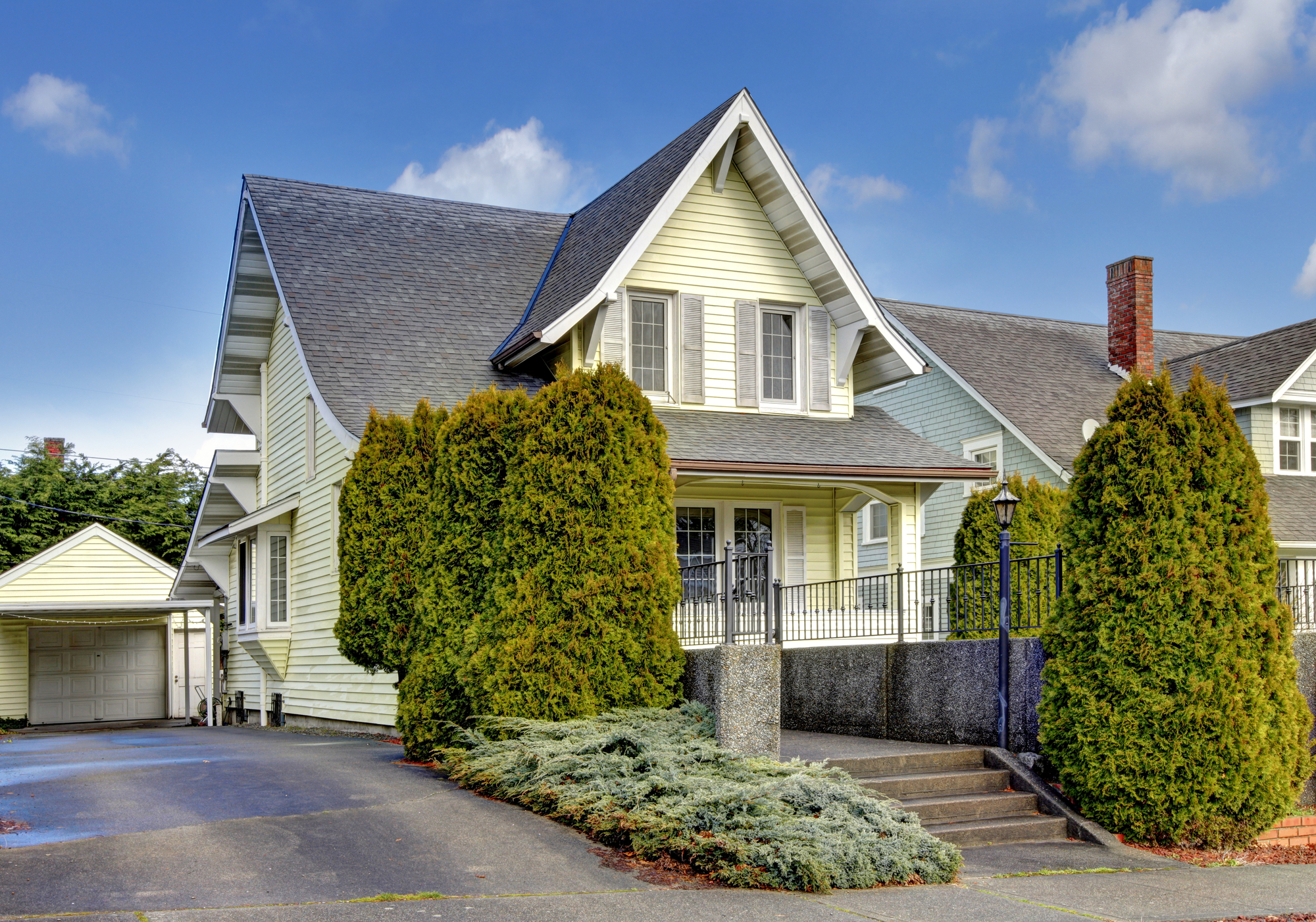 Craftsman style yellow house exterior.